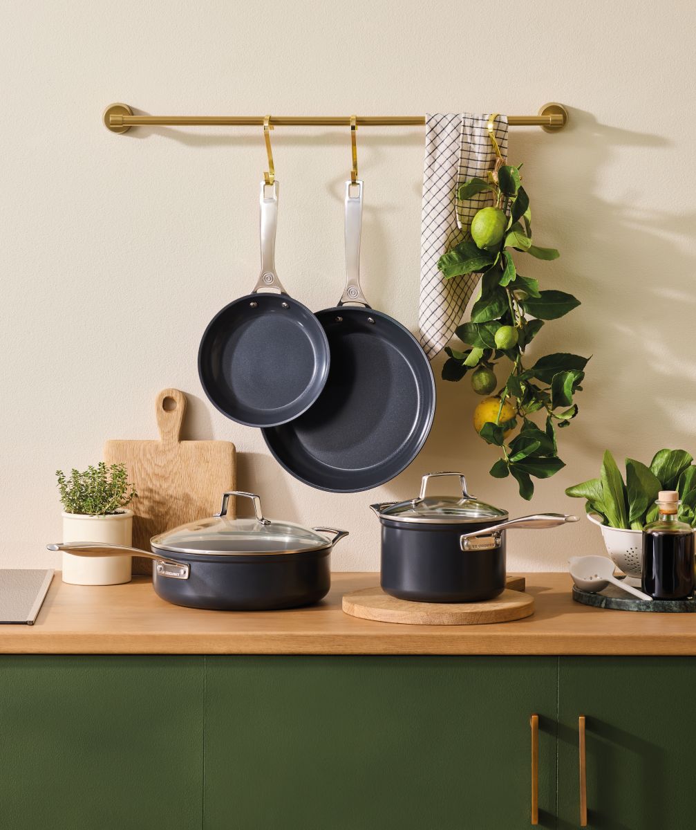 A collection of Le Creuset Ceramic non stick cookware in a kitchen.