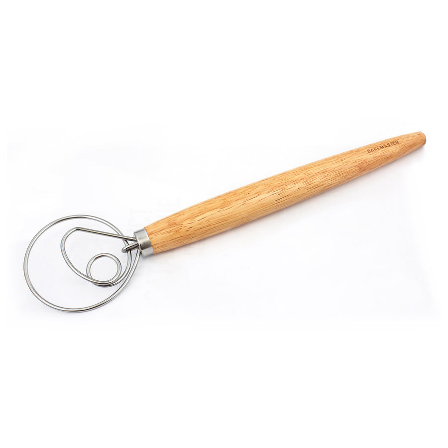 Wooden dough whisk on a white background