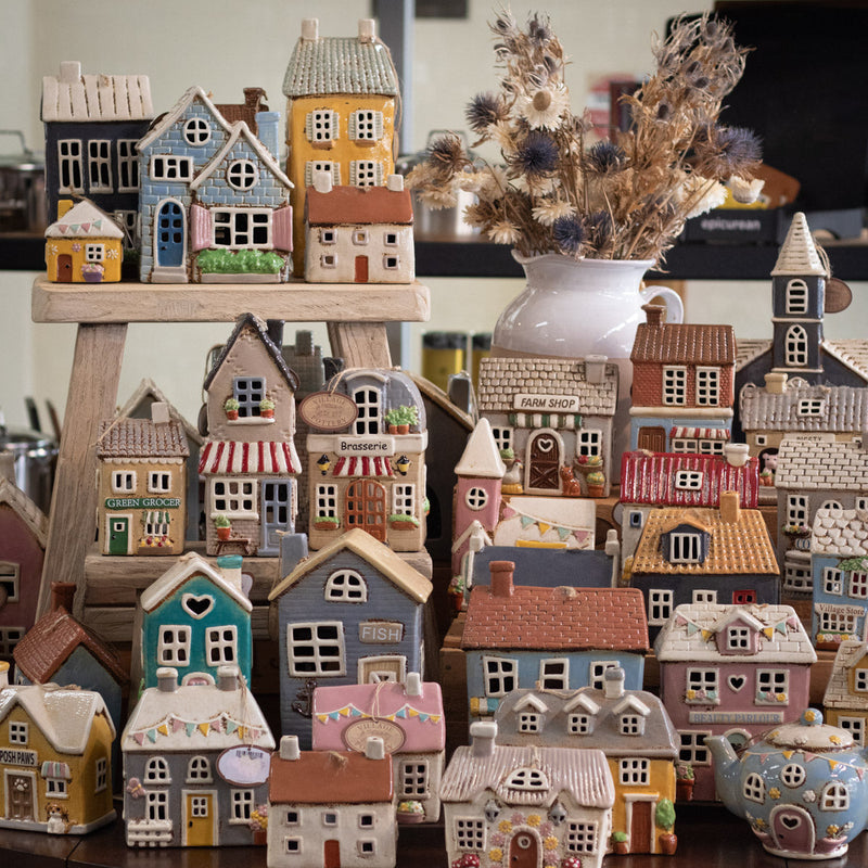 a shelfie of Village pottery tealight houses.