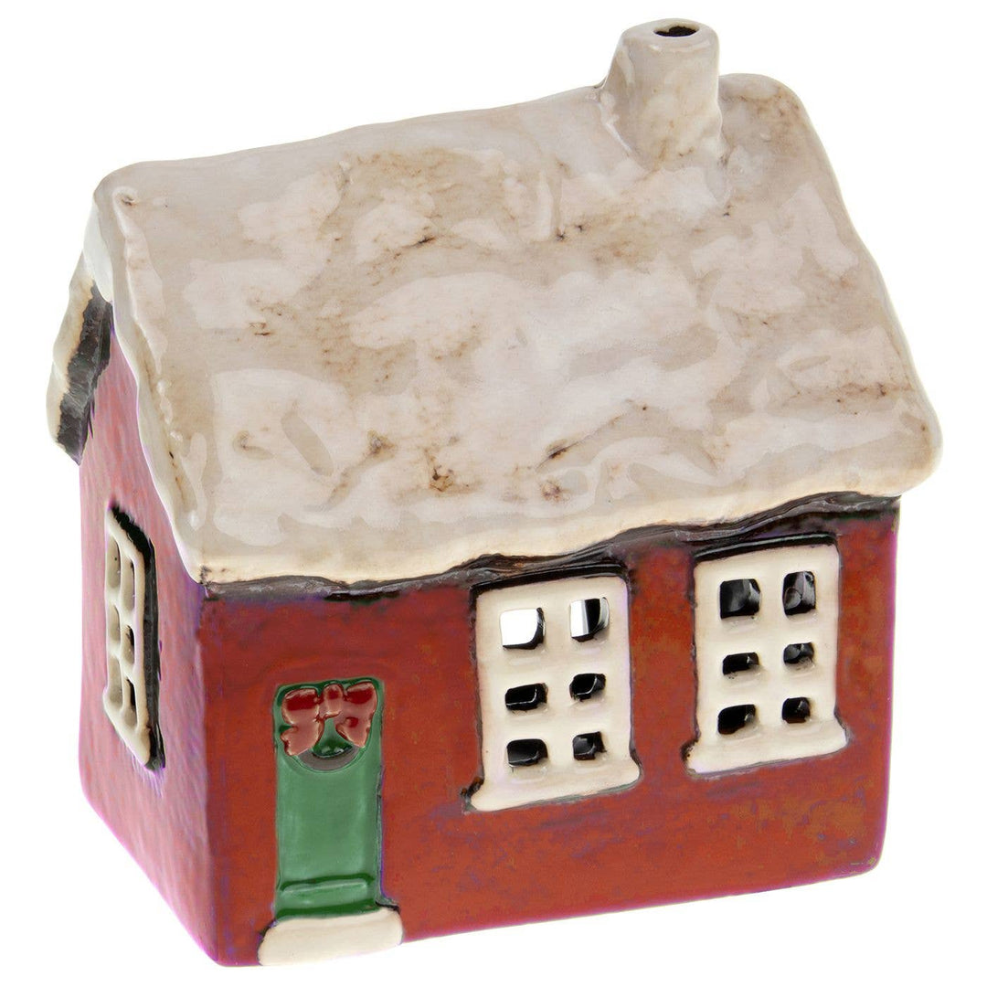Small Christmas ceramic tealight house with a textured roof on a white background