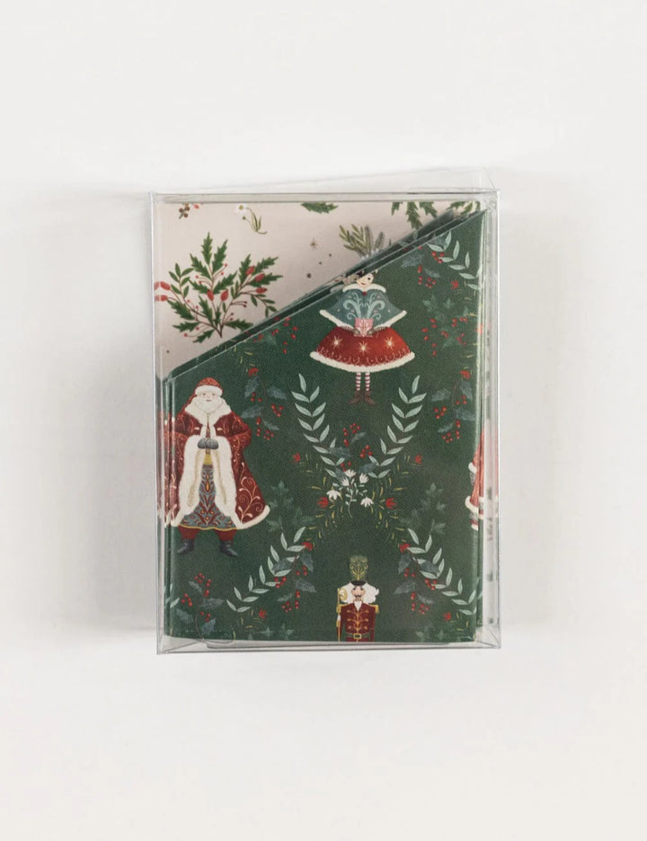 Packaged paper crowns with Santa Claus and holly design on a white background