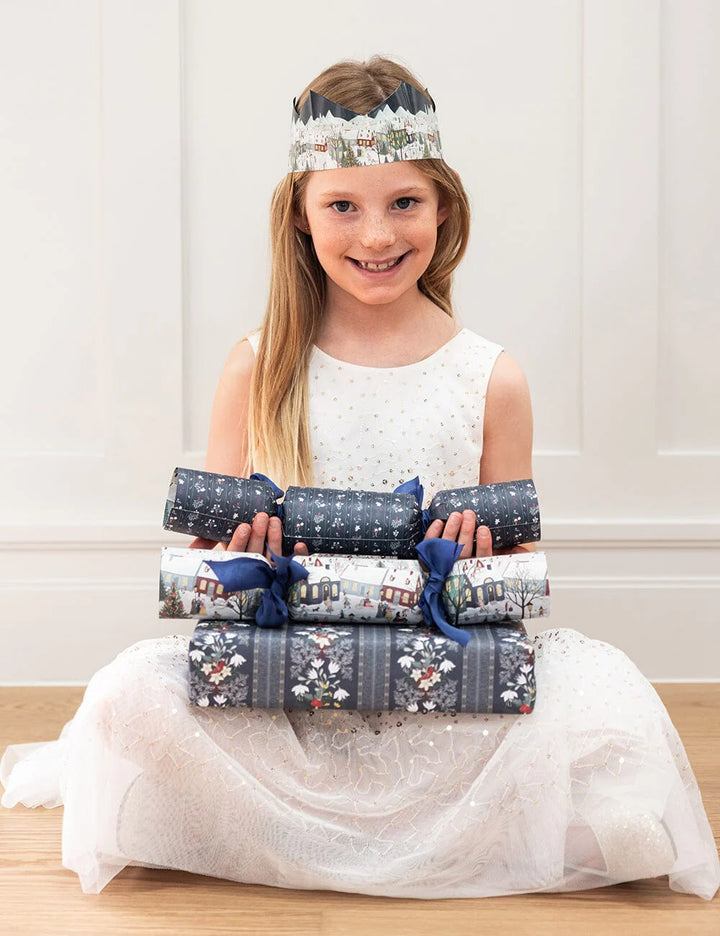 Young girl holding wrapped presents with a white background