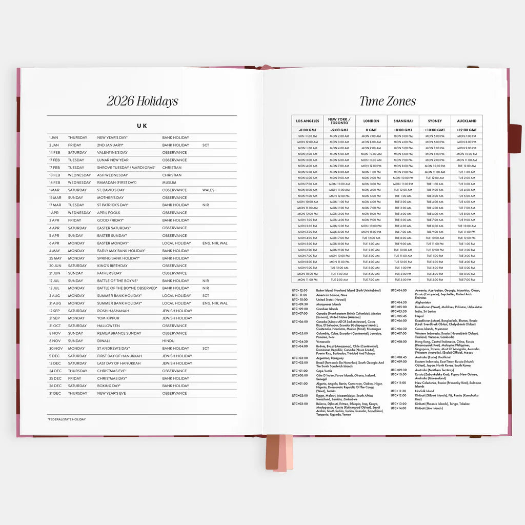 Open planner displaying a table of holidays and time zones for 2026.