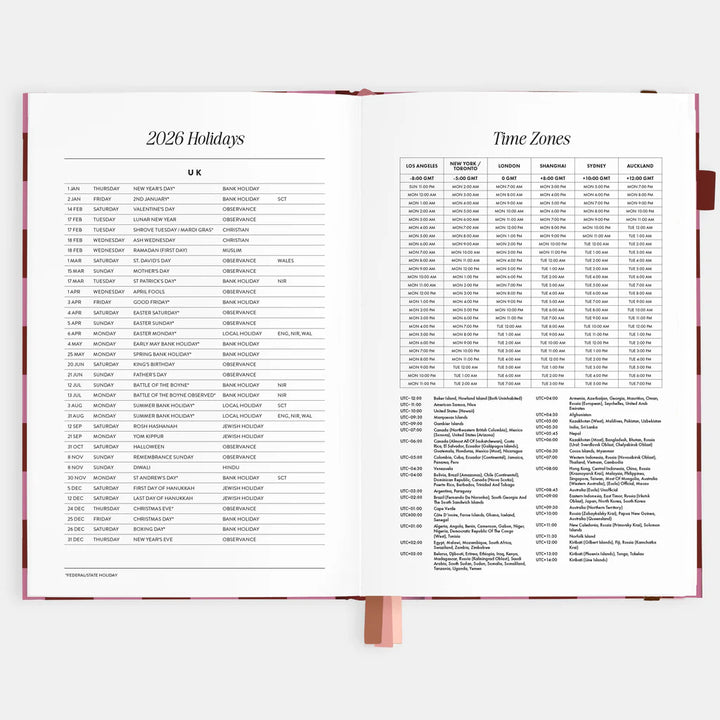 Open planner displaying a table of holidays and time zones for 2026.