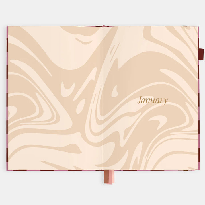 Marbled page in a planner with 'January' on a beige background