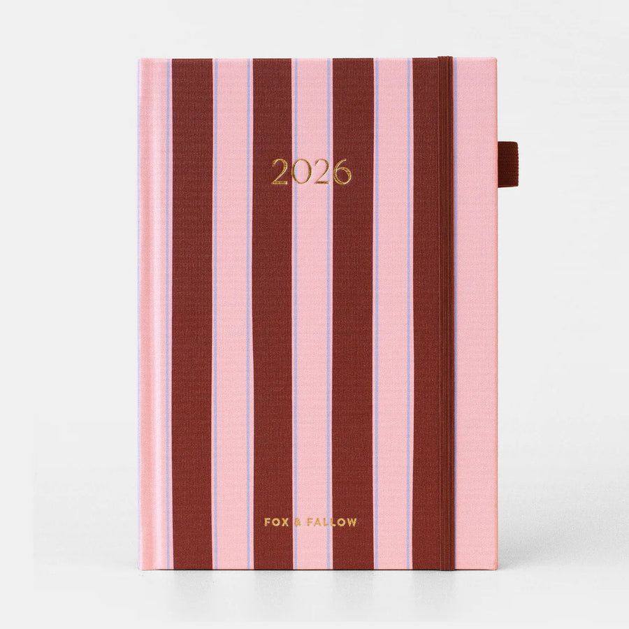 Striped planner with '2026' and 'FOX & FALLOW' on a white background