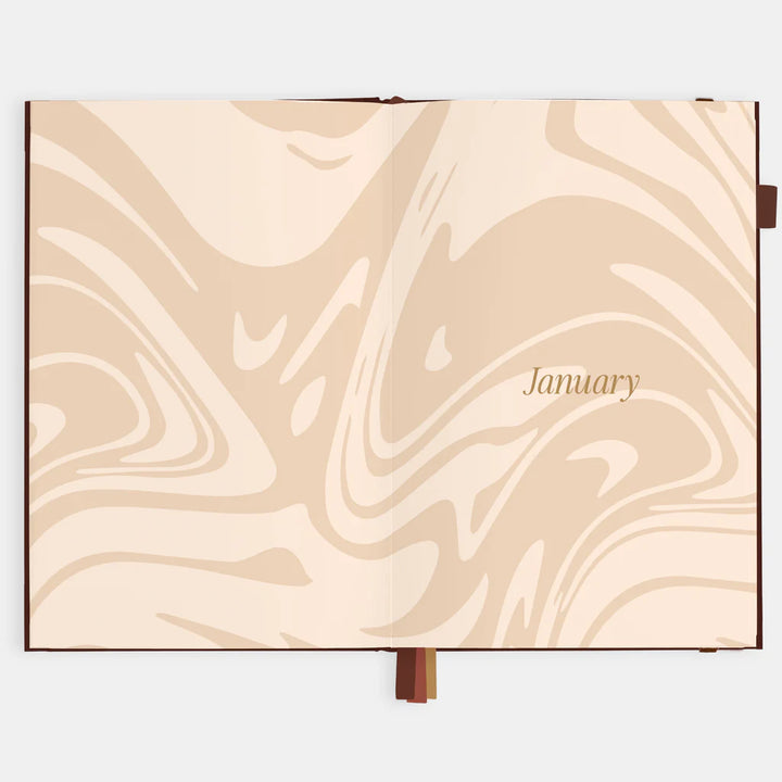 Marbled beige page from a planner with 'January' text on a white background