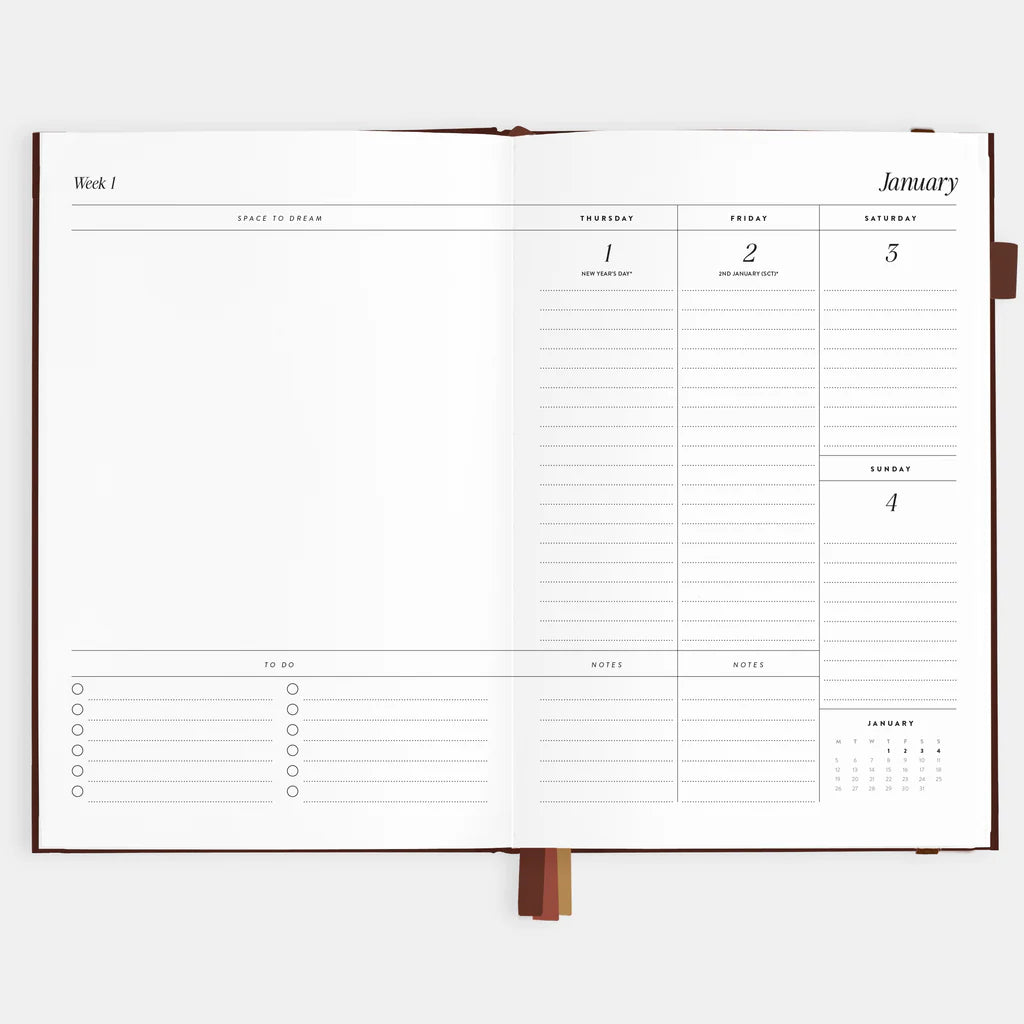 Open planner showing a weekly layout with days of the week and notes section on a white background.