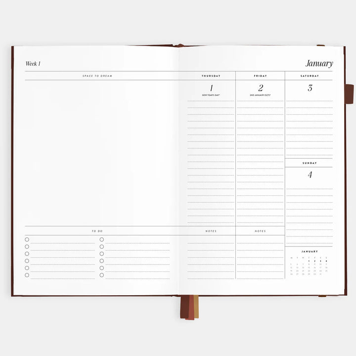 Open planner showing a weekly layout with days of the week and notes section on a white background.
