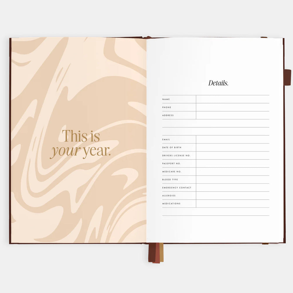 Open planner with marbled page and text on a white background