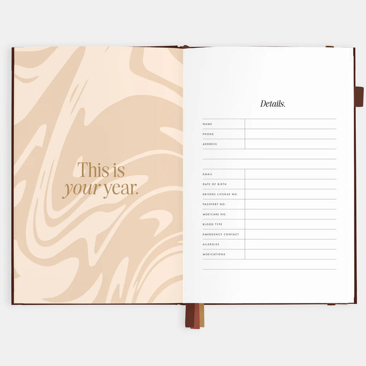Open planner with marbled page and text on a white background