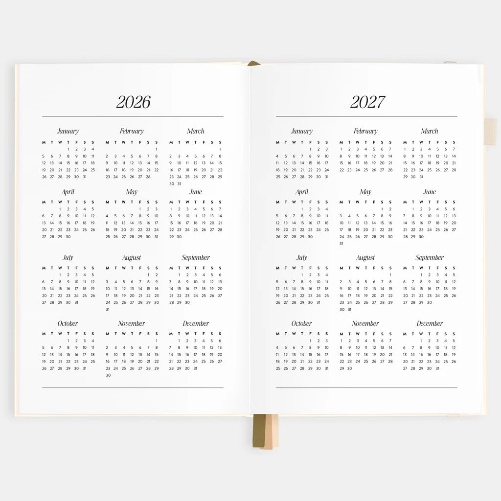 Two open planners showing calendar pages for 2026 and 2027 on a white background.