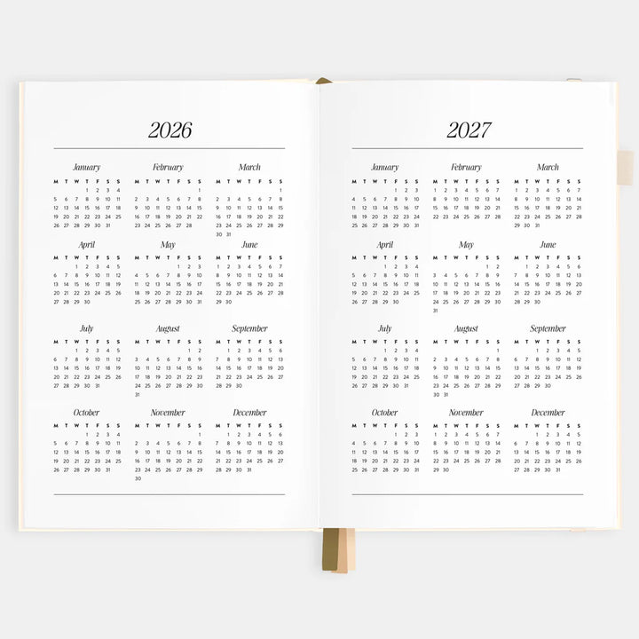 Two open planners showing calendar pages for 2026 and 2027 on a white background.
