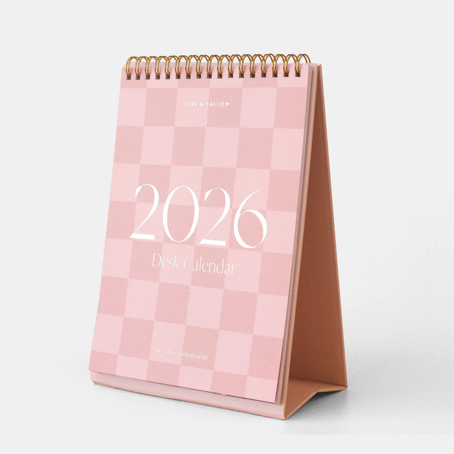 Pink checkered desk calendar for 2026 on a white background