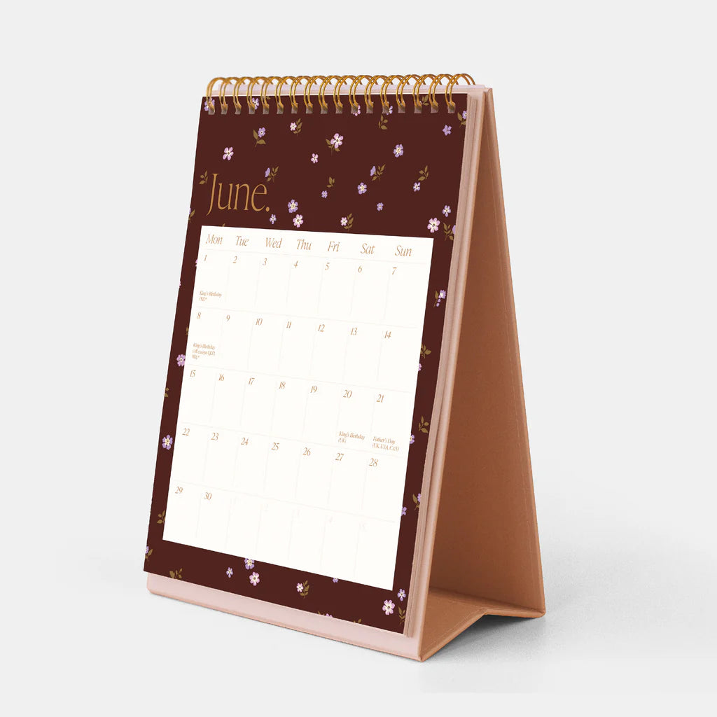 Tabletop calendar with a floral design on a white background
