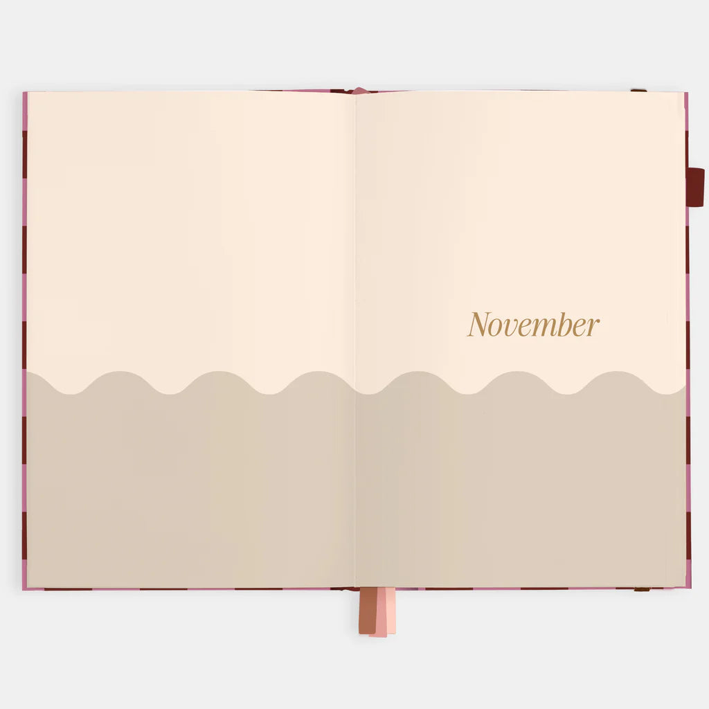 Open planner with 'November' on a beige background