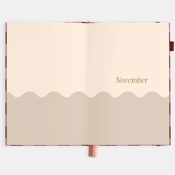 Open planner with 'November' on a beige background