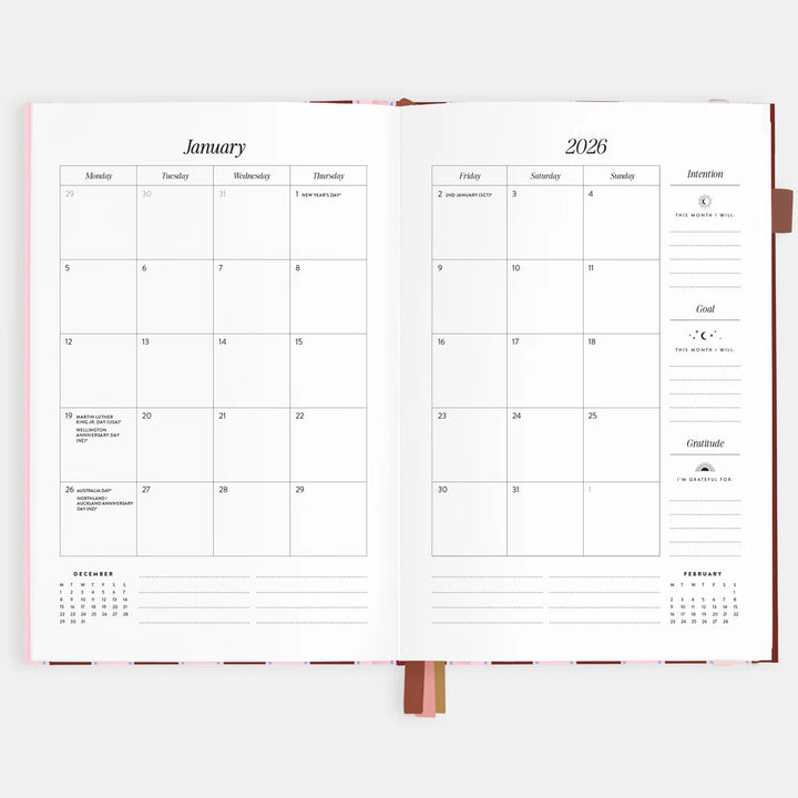 Open planner showing a two-page spread for January 2026 with calendar and notes sections.