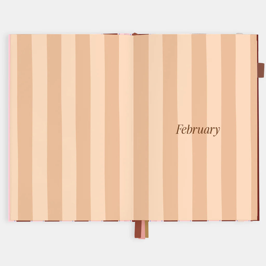Striped notebook with 'February' text on a light gray background