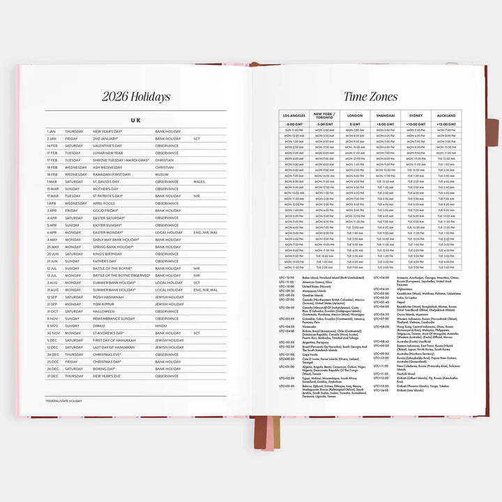 Open book showing pages with 2026 holidays and time zones lists.