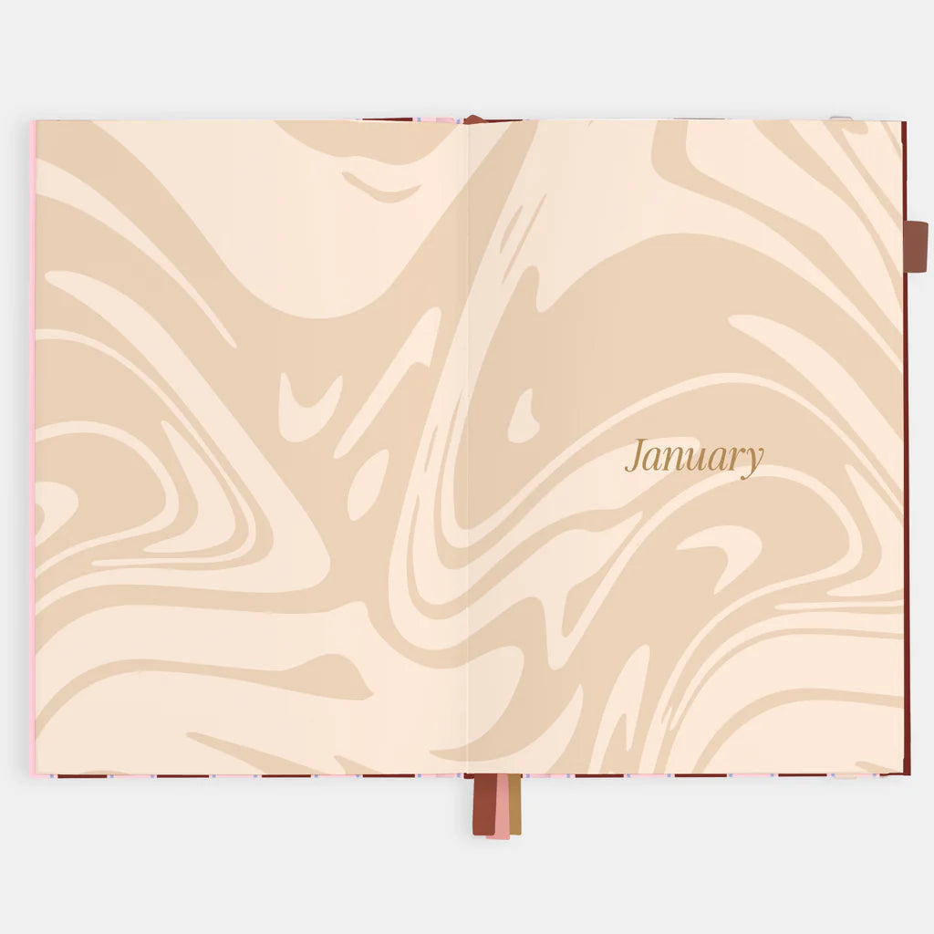 Marbled page in a beige planner with 'January' text on a white background