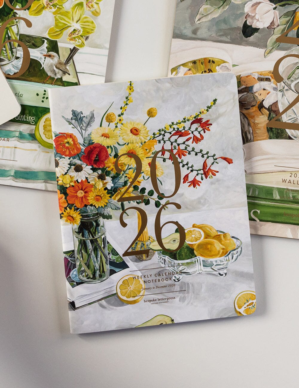 Calendar with floral design and numbers '2026' on a white surface