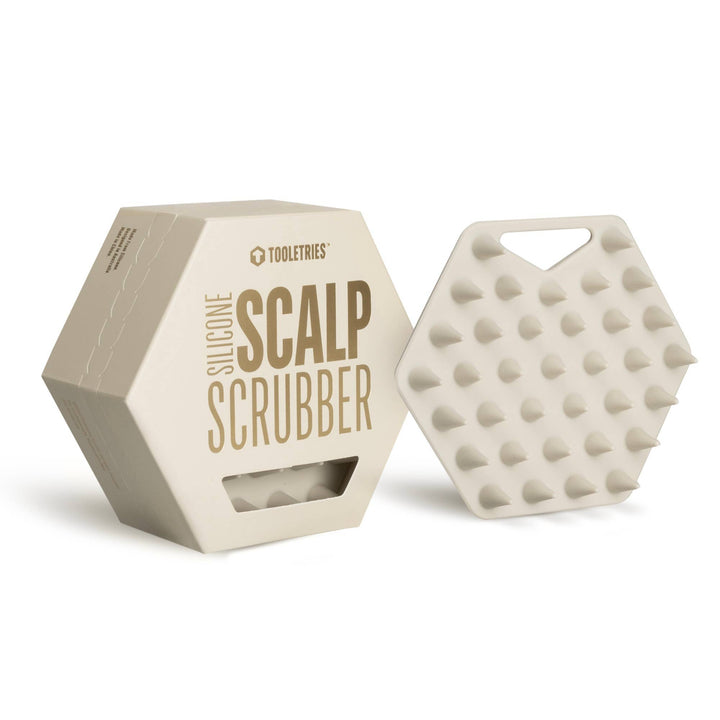 Silicone scalp scrubber with packaging on a white background