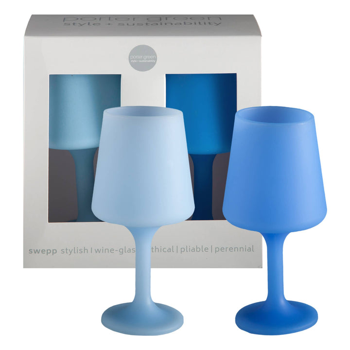 Two blue silicone unbreakable wine glasses in front of a branded box on a white background