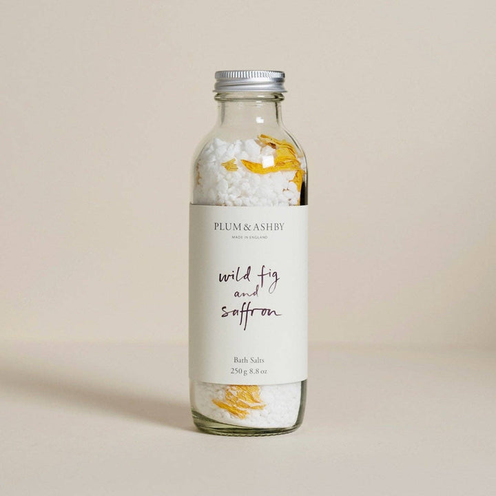 A glass bottle of Plum &amp; Ashby bath salts with a white label reading &