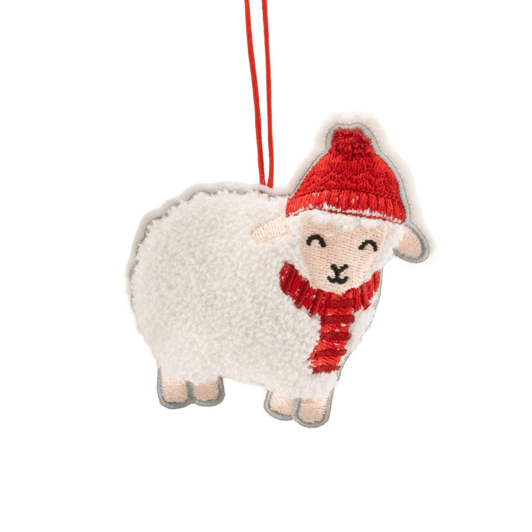 A plush sheep-shaped hanging ornament with a red knit hat and matching red scarf, shown on a plain white background.