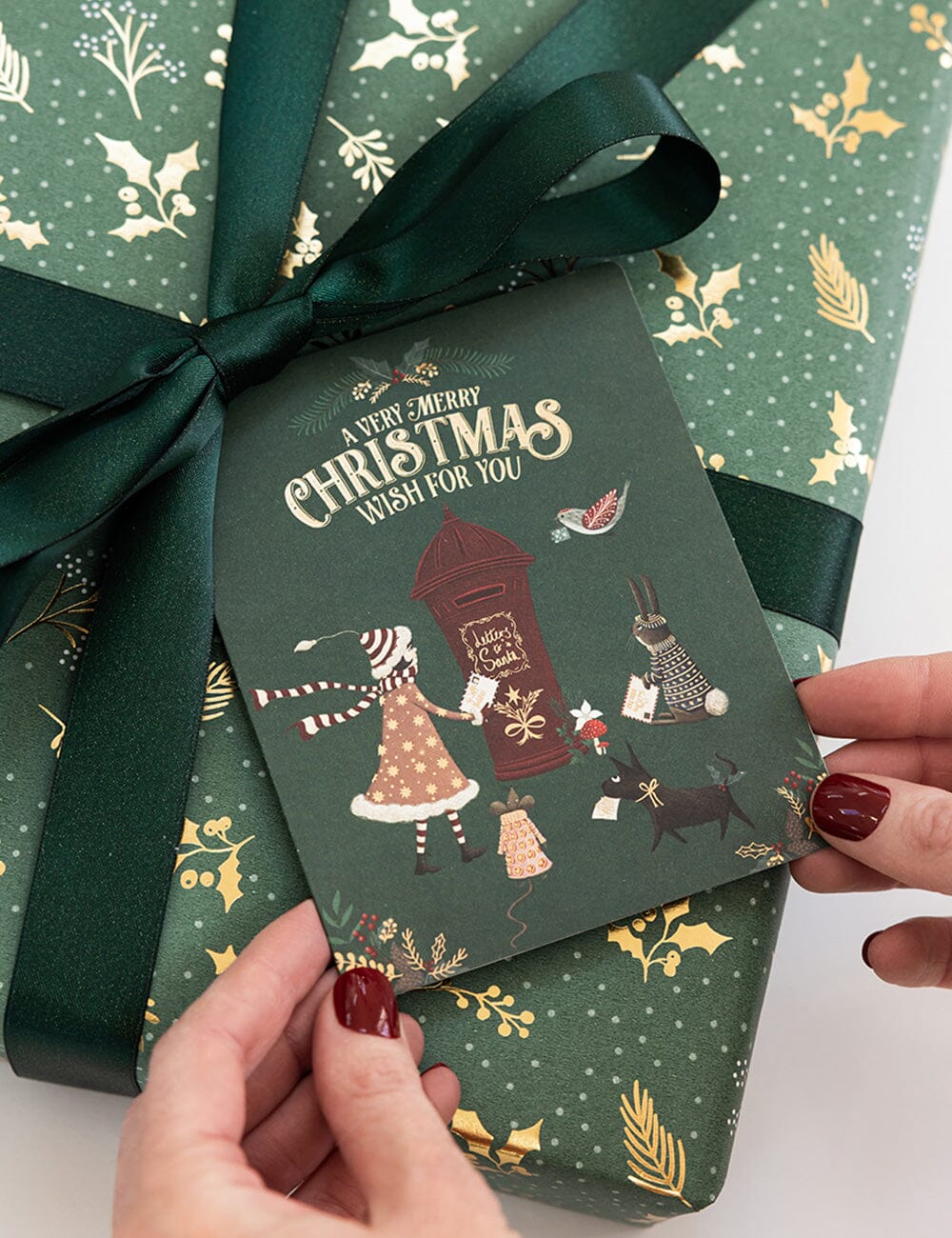 Gift box with a Christmas-themed card and decorative ribbon