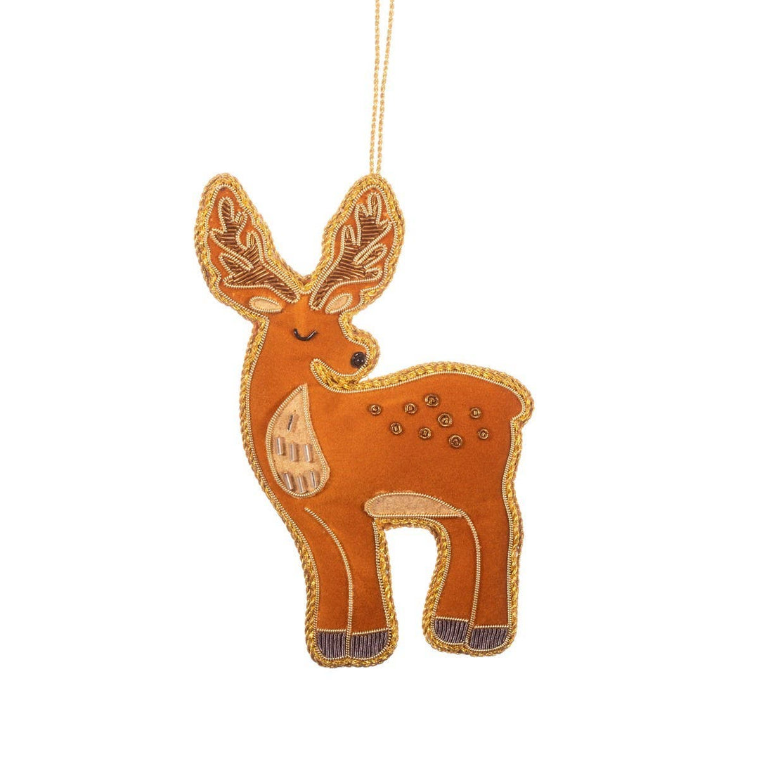 A brown felt Christmas ornament shaped like a deer, featuring gold embroidered details, a gold hanging string, and small metallic studs on a plain white background.