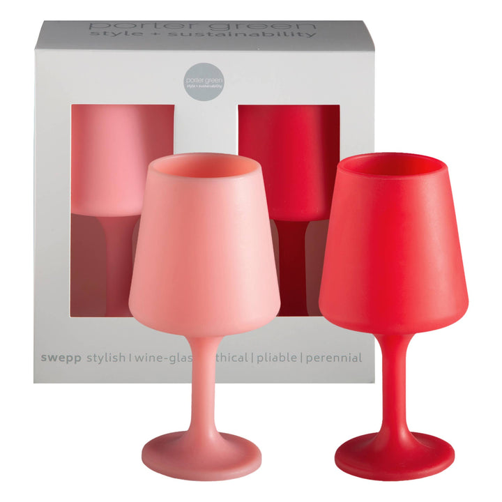 Two silicone unbreakable red and pink wine glasses in front of a white box with product information.