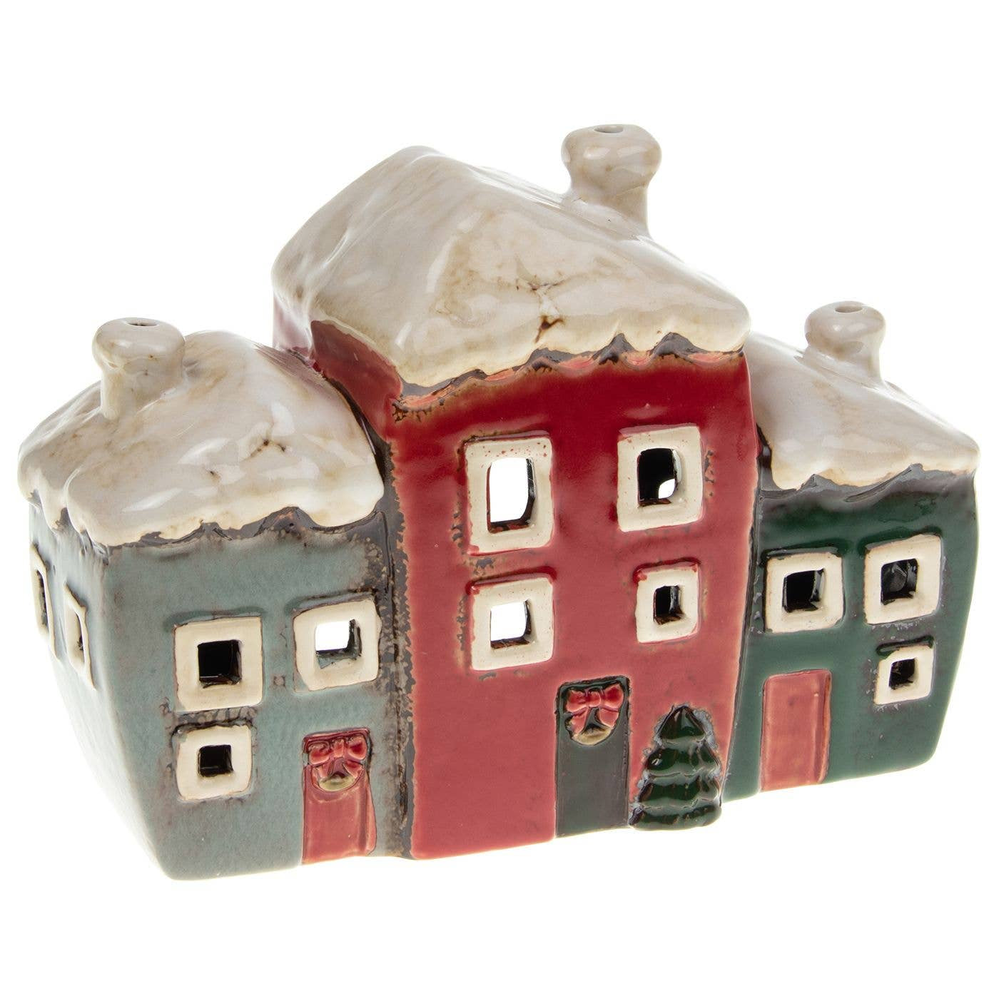 A ceramic miniature house-shaped candle holder featuring three connected houses in muted red, gray, and green with white snow-covered roofs, shown on a plain white background.