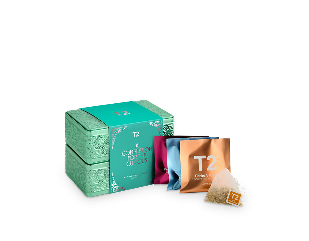T2 tea packaging including a box, packets, and a teabag on a white background