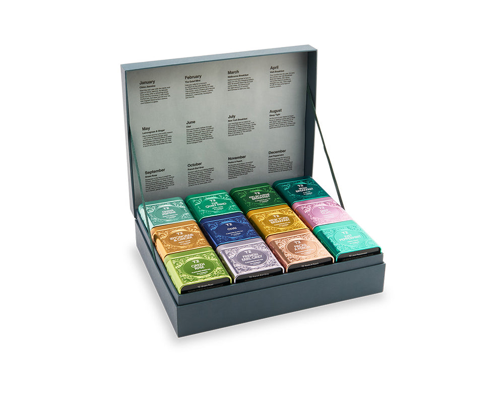 Collection of colorful tea bags in a display box on a white background