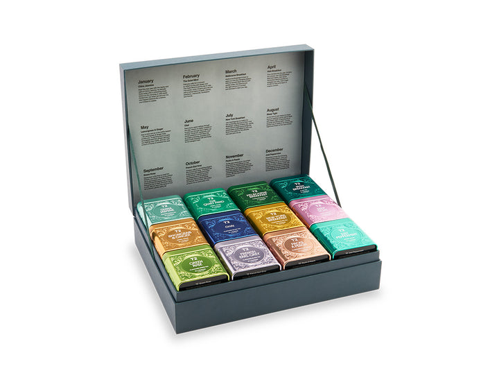 Collection of colorful tea bags in a display box on a white background