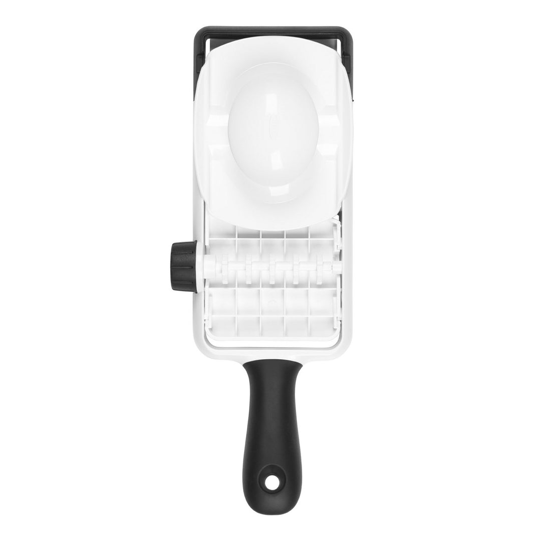 Black and white mandoline slicer on a white background