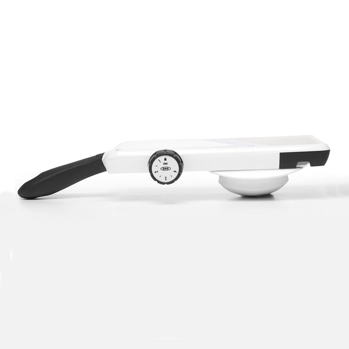 White mandoline slicer with black handle on a white background