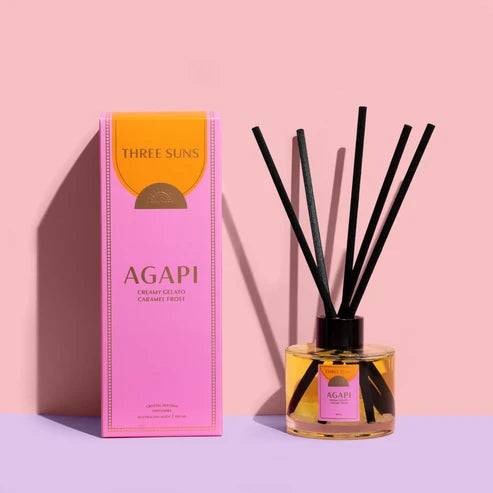 Three Suns Agapi reed diffuser &amp; packaging on a pale pink background