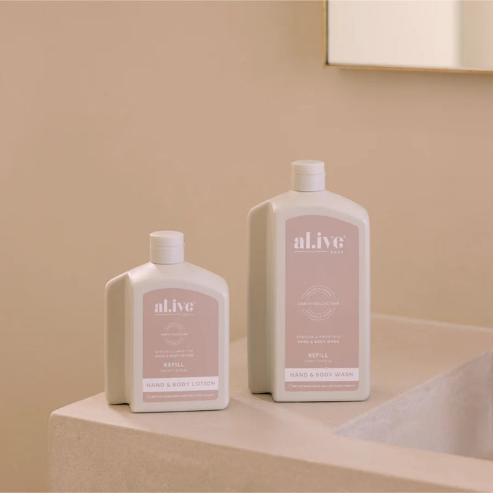 Two bottles of 'alive' products on a beige surface with a neutral background