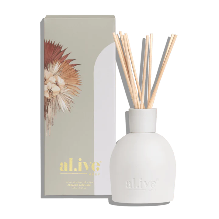 White diffuser bottle with wooden sticks and packaging labeled 'alive' on a white background