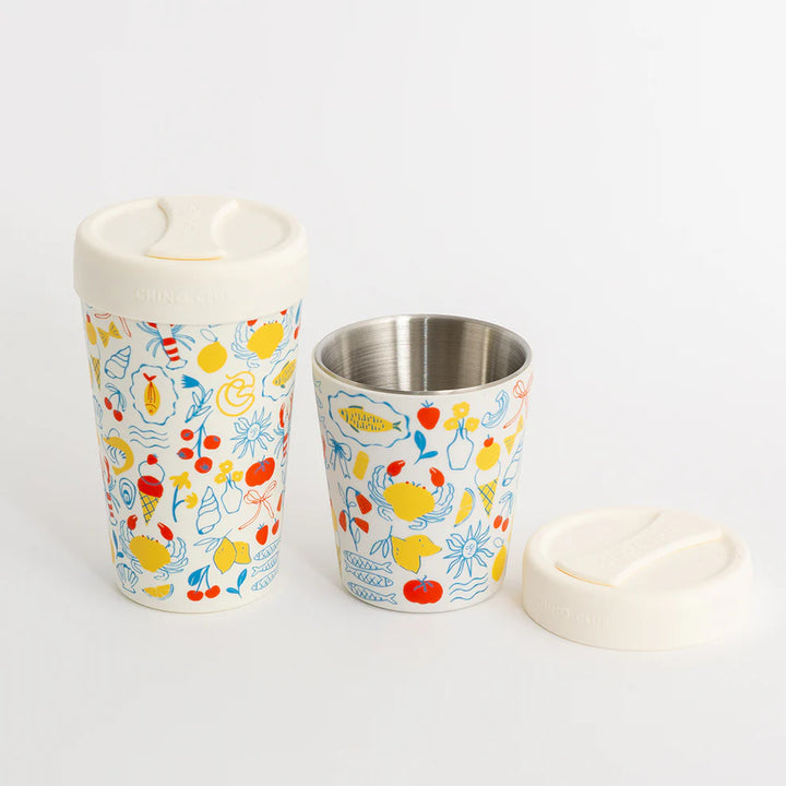 Two reusable cups with colorful sea-themed pattern on a white background
