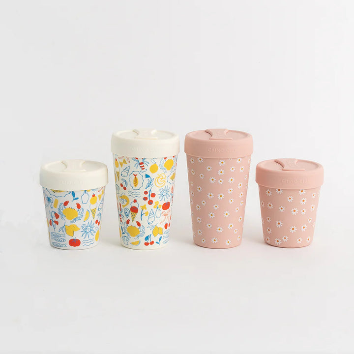 Four patterned cups on a light gray background