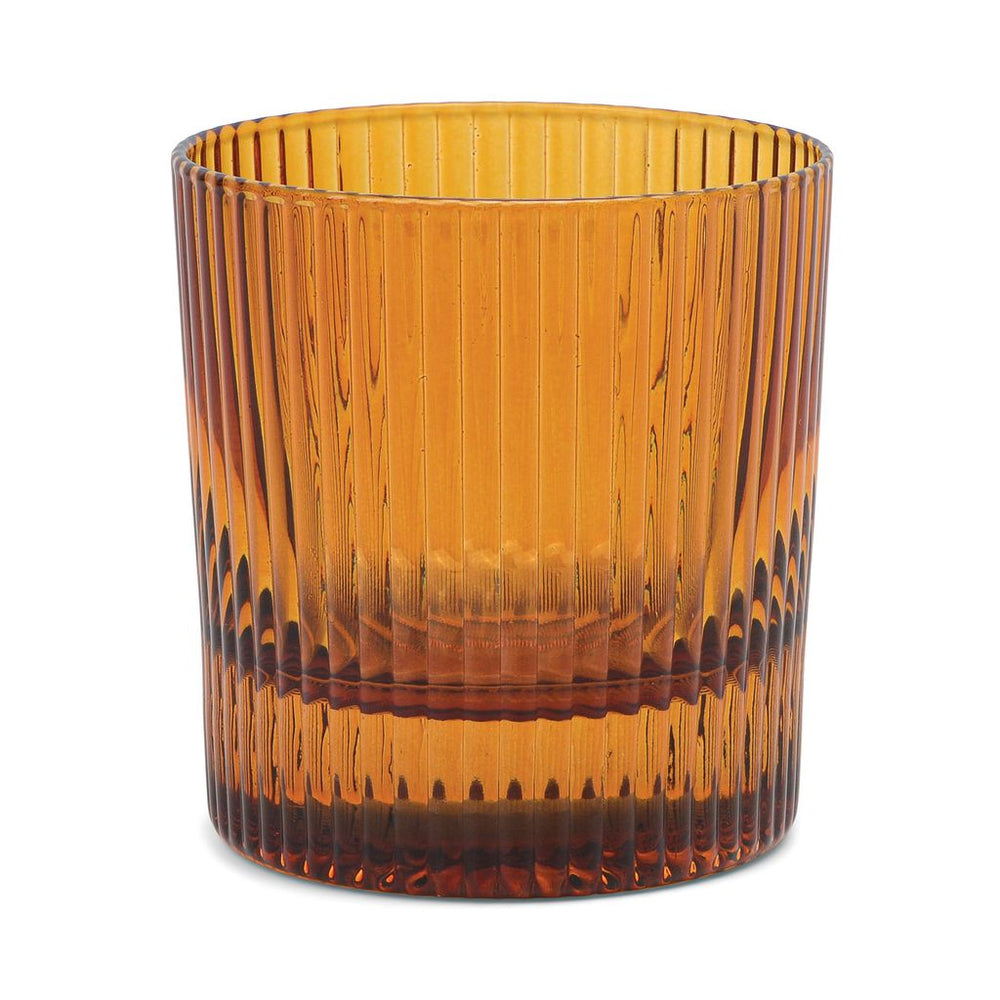 Amber glass tumbler with ribbed texture on a white background