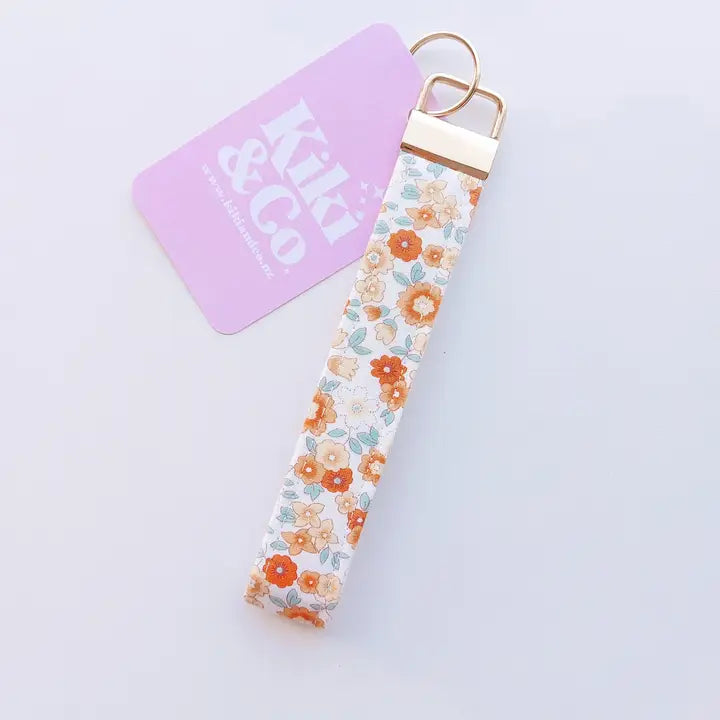 Orange and blue floral keychain on a white background 