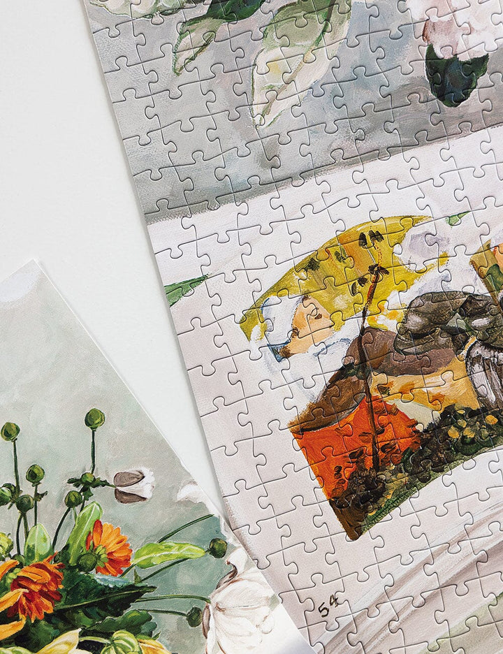 Jigsaw puzzle with a partially completed scene of a woman with flowers and a cat.