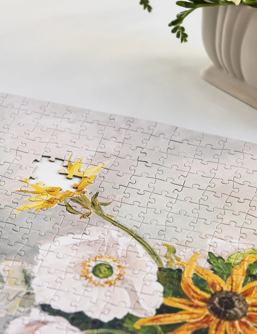 Jigsaw puzzle with floral design on a white surface
