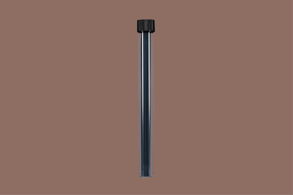 Black cylindrical object with incense sticks inside on a brown background