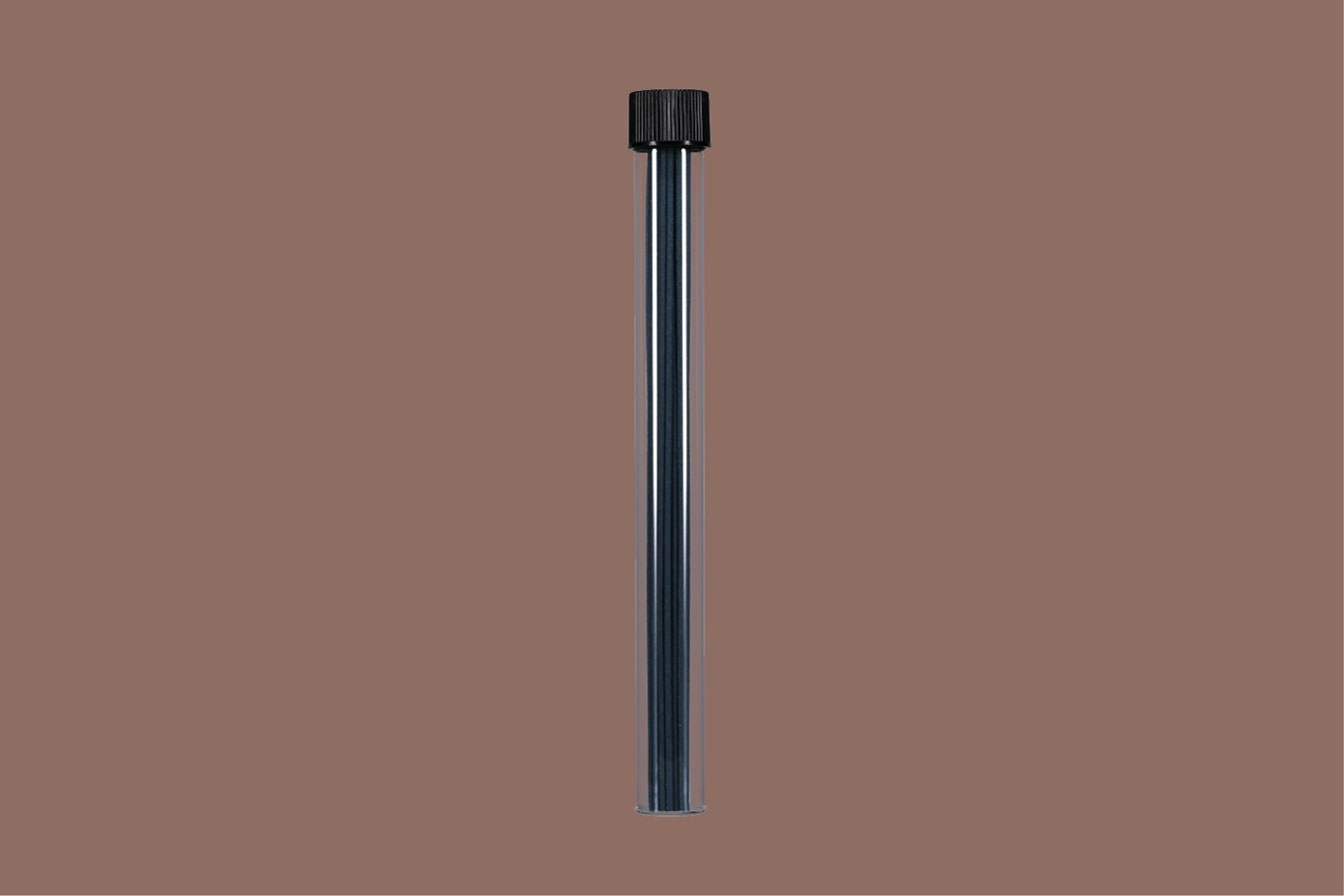 Black cylindrical object with incense sticks inside on a brown background